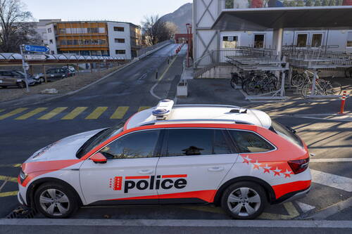 epa12622458 A police car in front of the 'Hospital Du Valais' building after the fire at the 'Le Constellation' bar and lounge, in Sion, Switzerland, 03 January 2026. At least 40 people lost their lives and over 100 were severely injured in the fire that devastated the bar 'Le Constellation' on New Year's Eve in the Swiss Alps resort of Crans-Montana.  EPA/JEAN-CHRISTOPHE BOTT